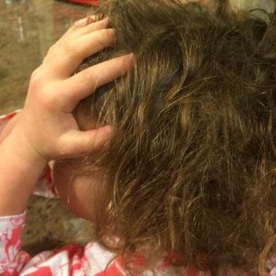 Child with her head in her hands