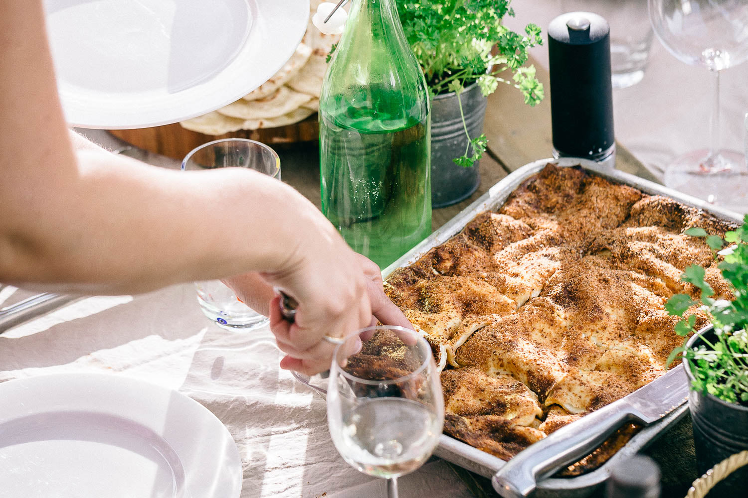 Beef lasagne being cut and served on a table