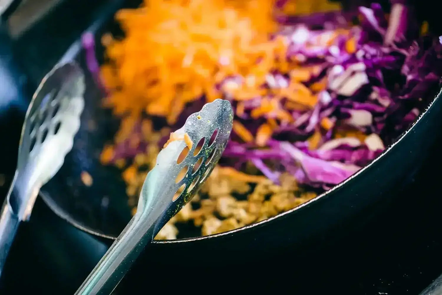 Cooking vegetables and meat in a pan.