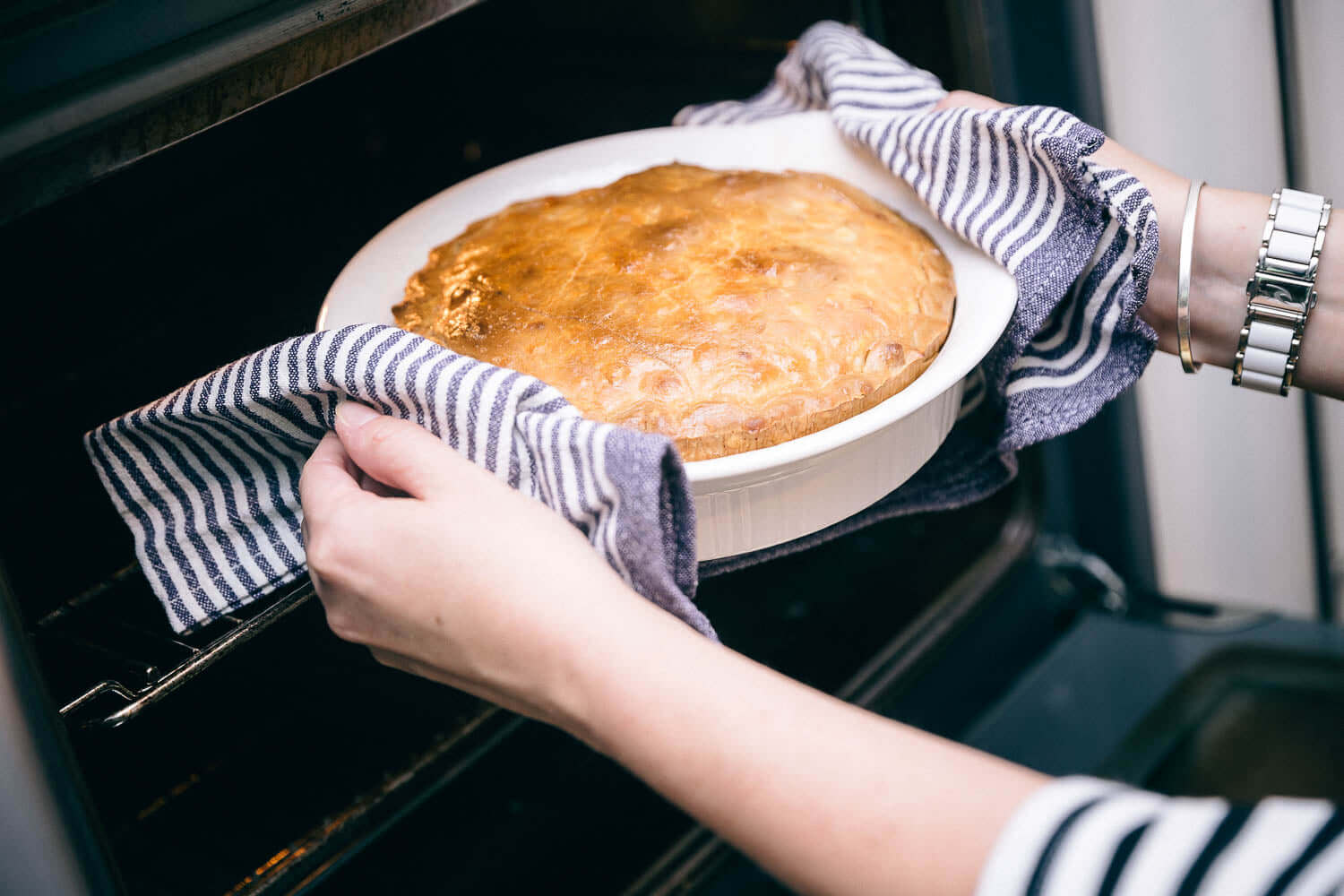 Removing a pie from the oven