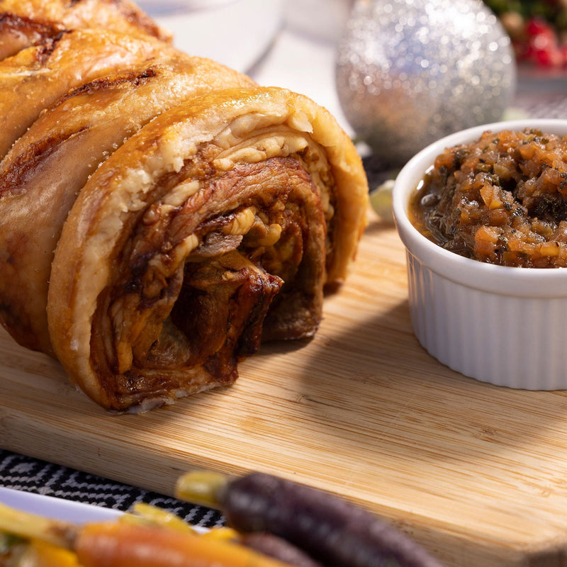 Roast pork belly roll with crispy crackling and apple and sage sauce