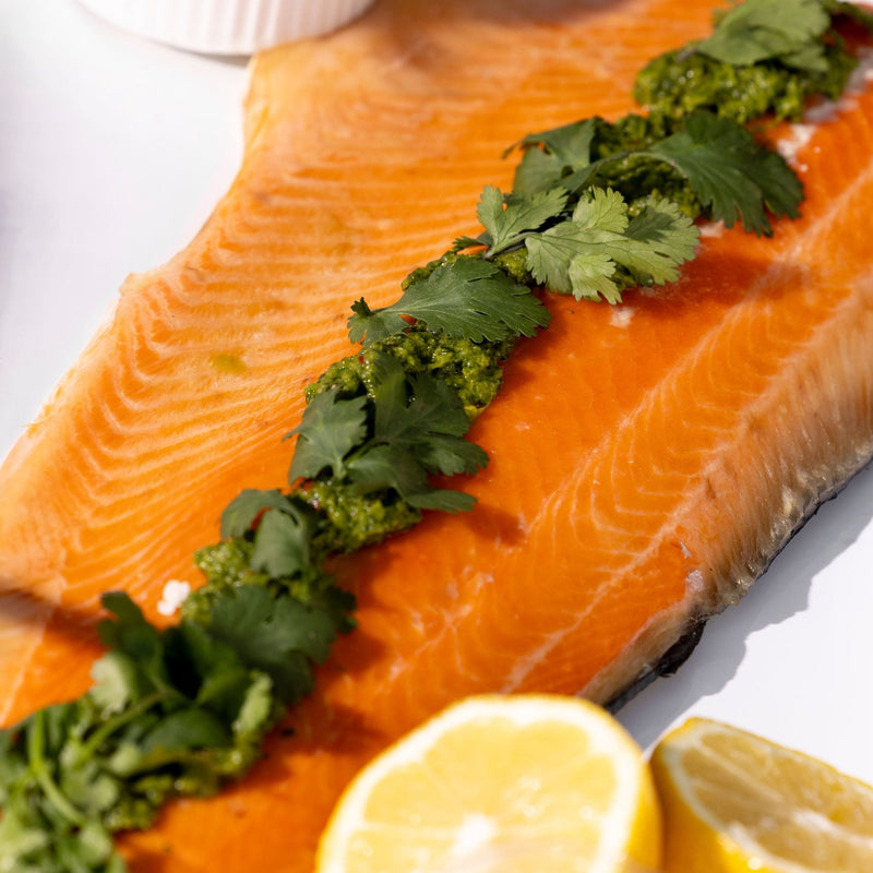 Hot smoked side of salmon dressed with chimichurri and coriander