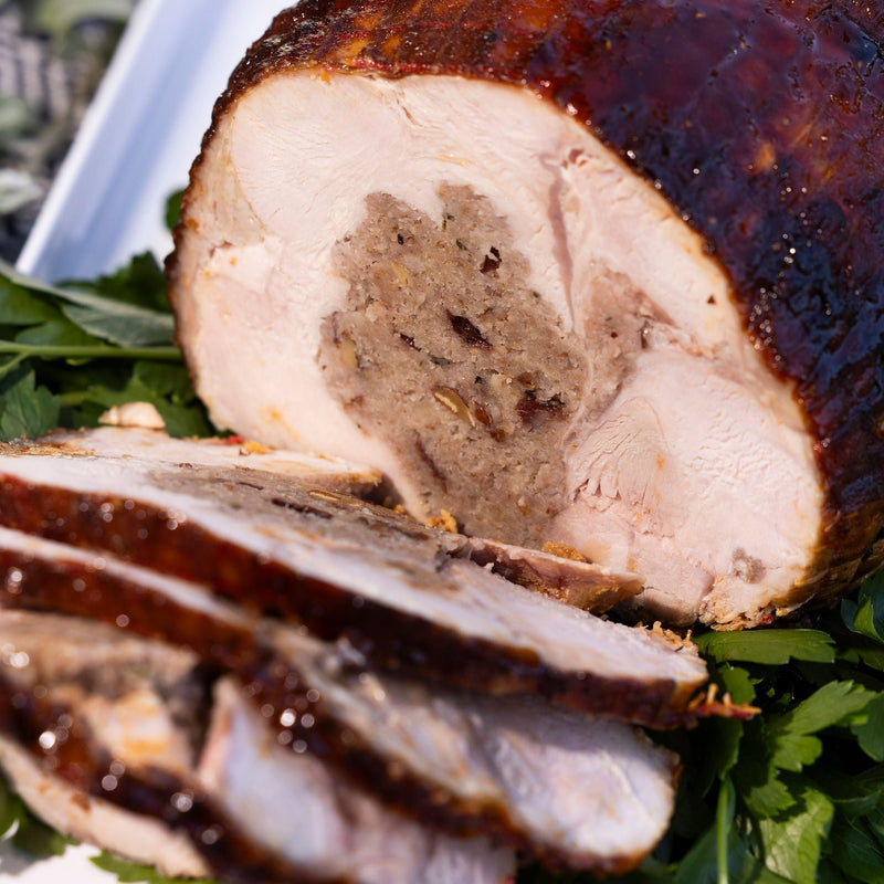 Sliced roast turkey breast roll on a serving platter