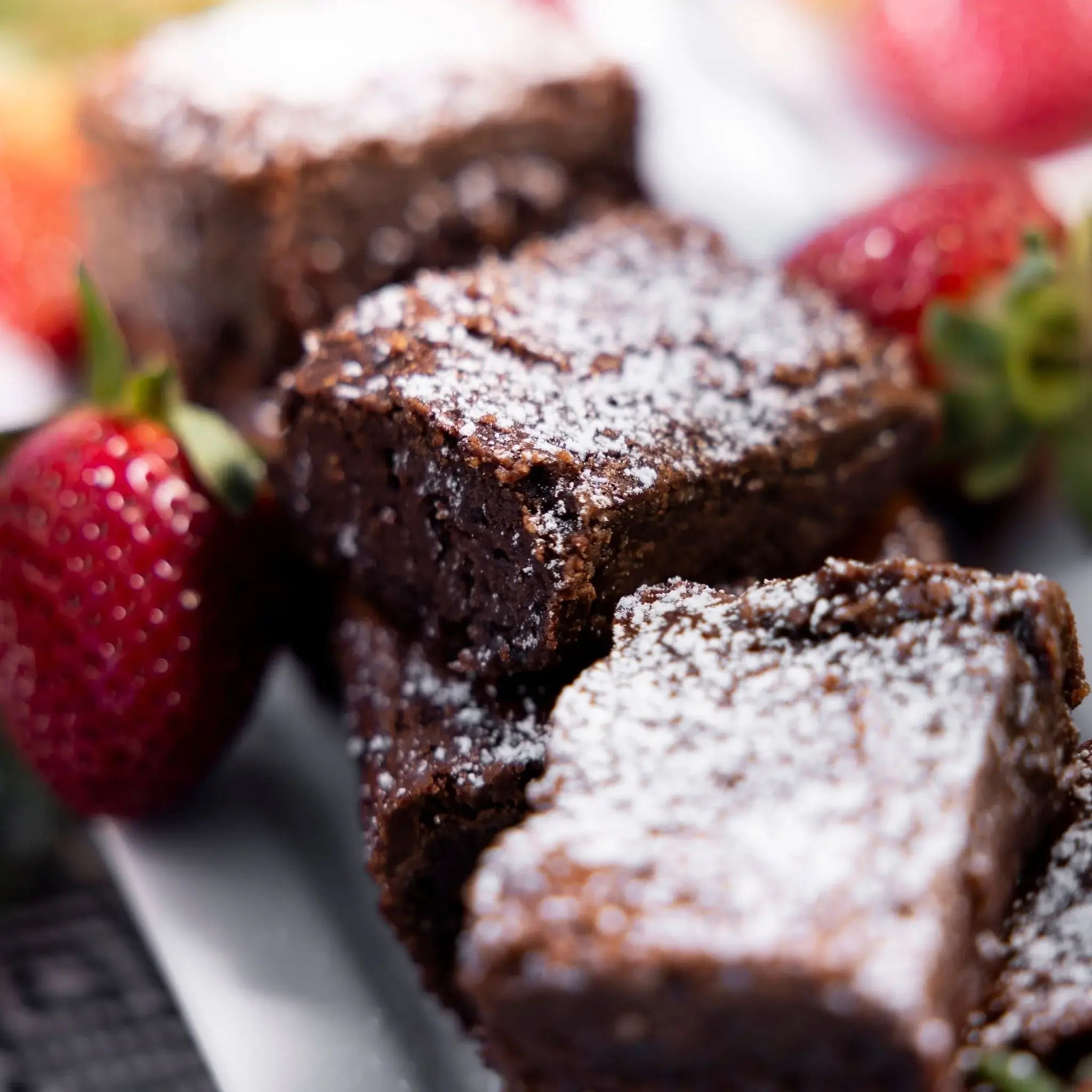 Brownies with powdered sugar and strawberries