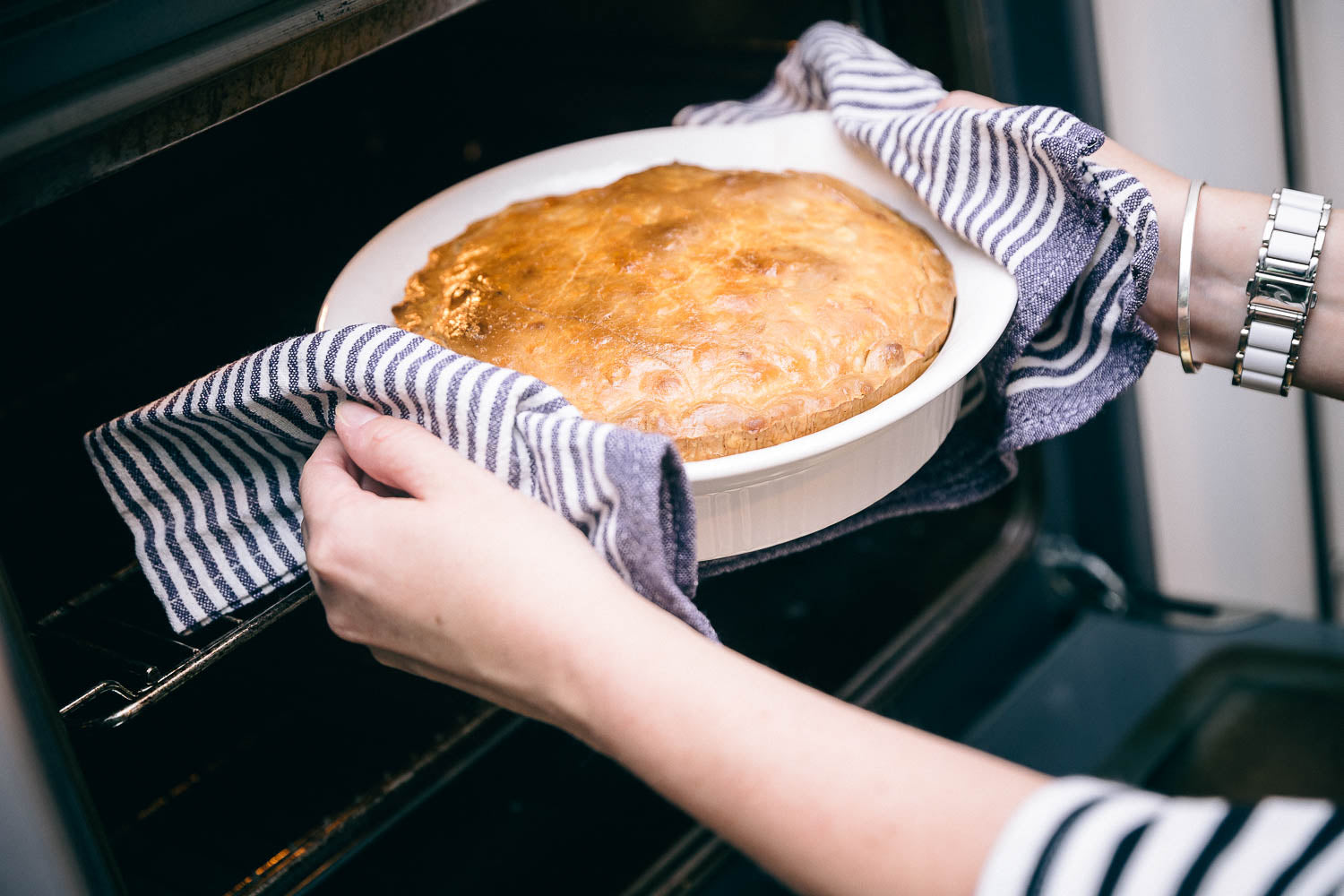 Chicken and leek pie being lifted out of the oven