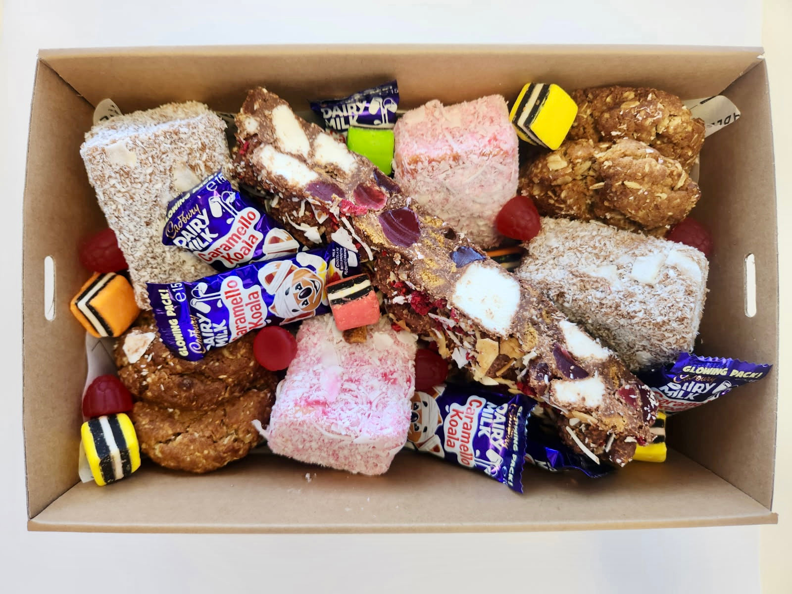 A boxed assortment of lamingtons, rocky road, Anzac biscuits and quintessential Australian lollies.