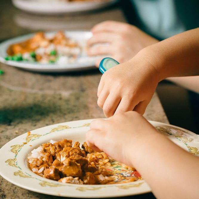 ready made home delivery meals featuring a child eating curry