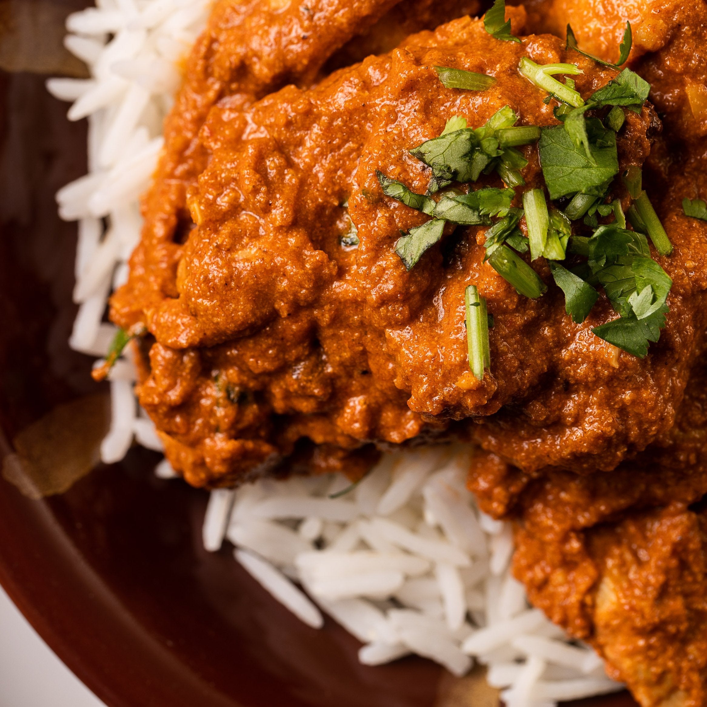 ready made home delivery meals featuring butter chicken on rice