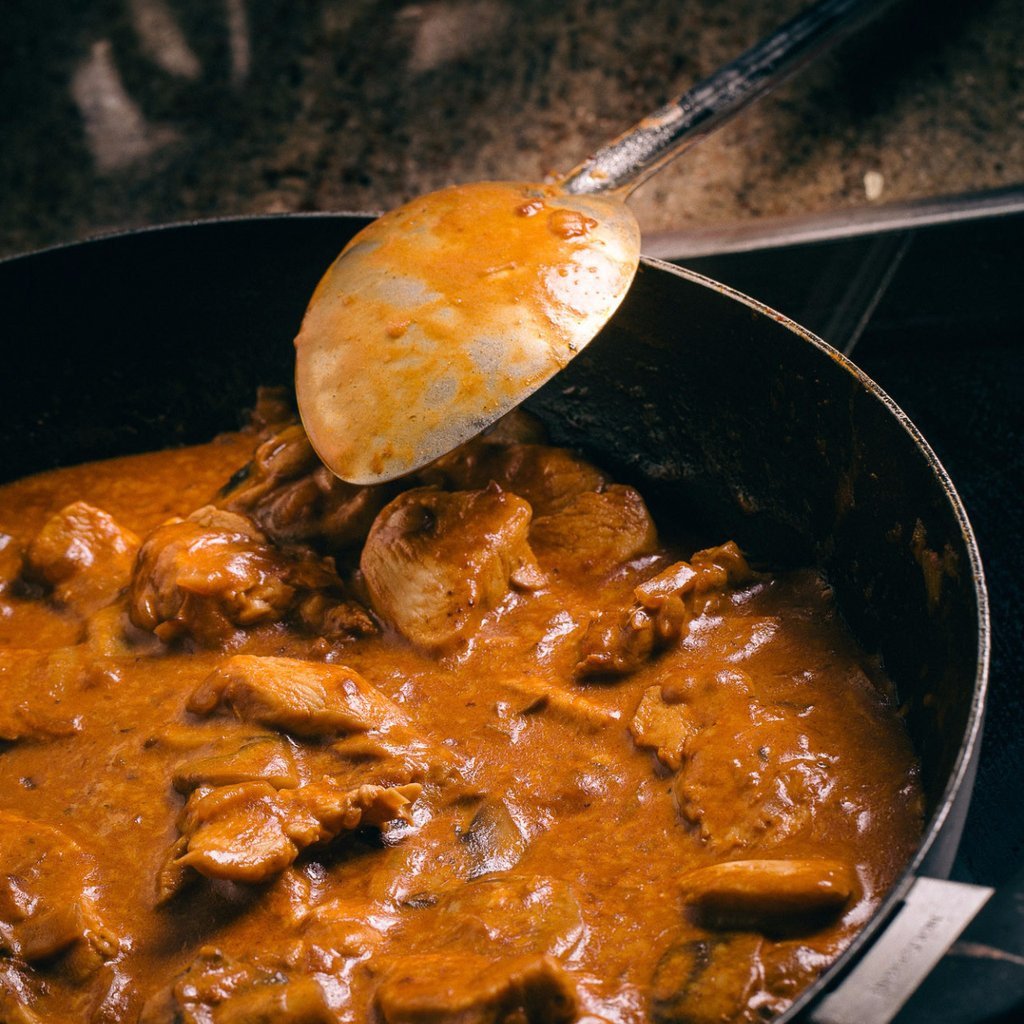 ready made home delivery meals featuring chicken and mushroom in a cooking pan